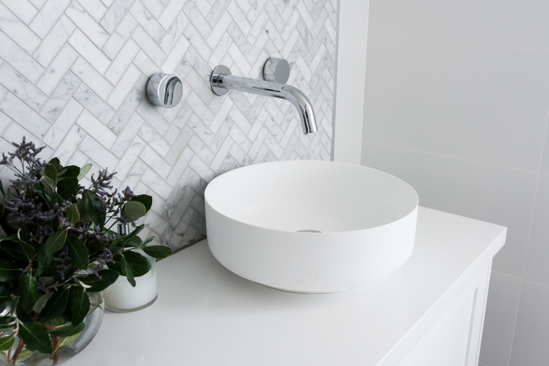 cararra herringbone mosaic feature wall in a modern bathroom from amber
