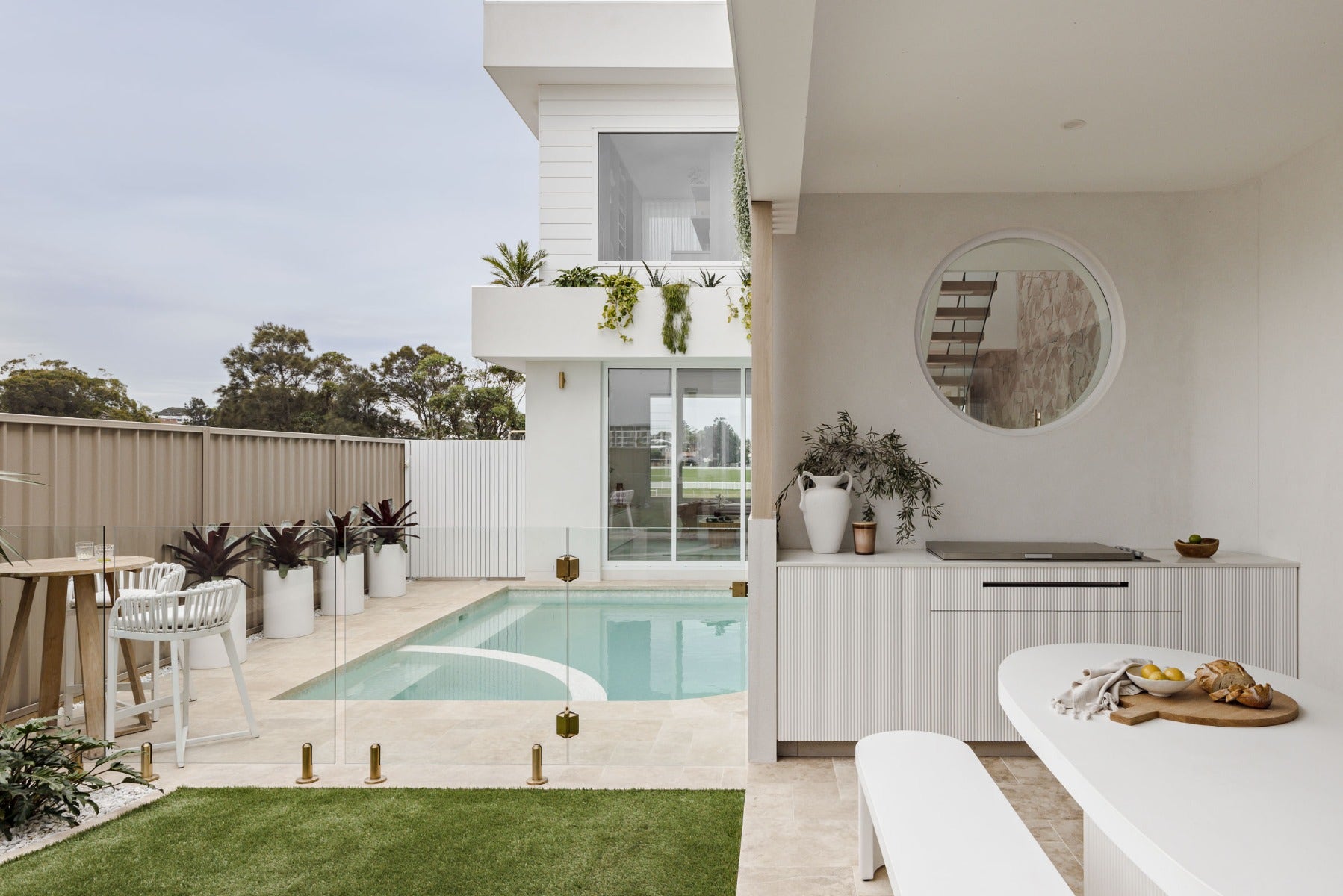 travertine pavers around a luxurious pool and alfresco from amber
