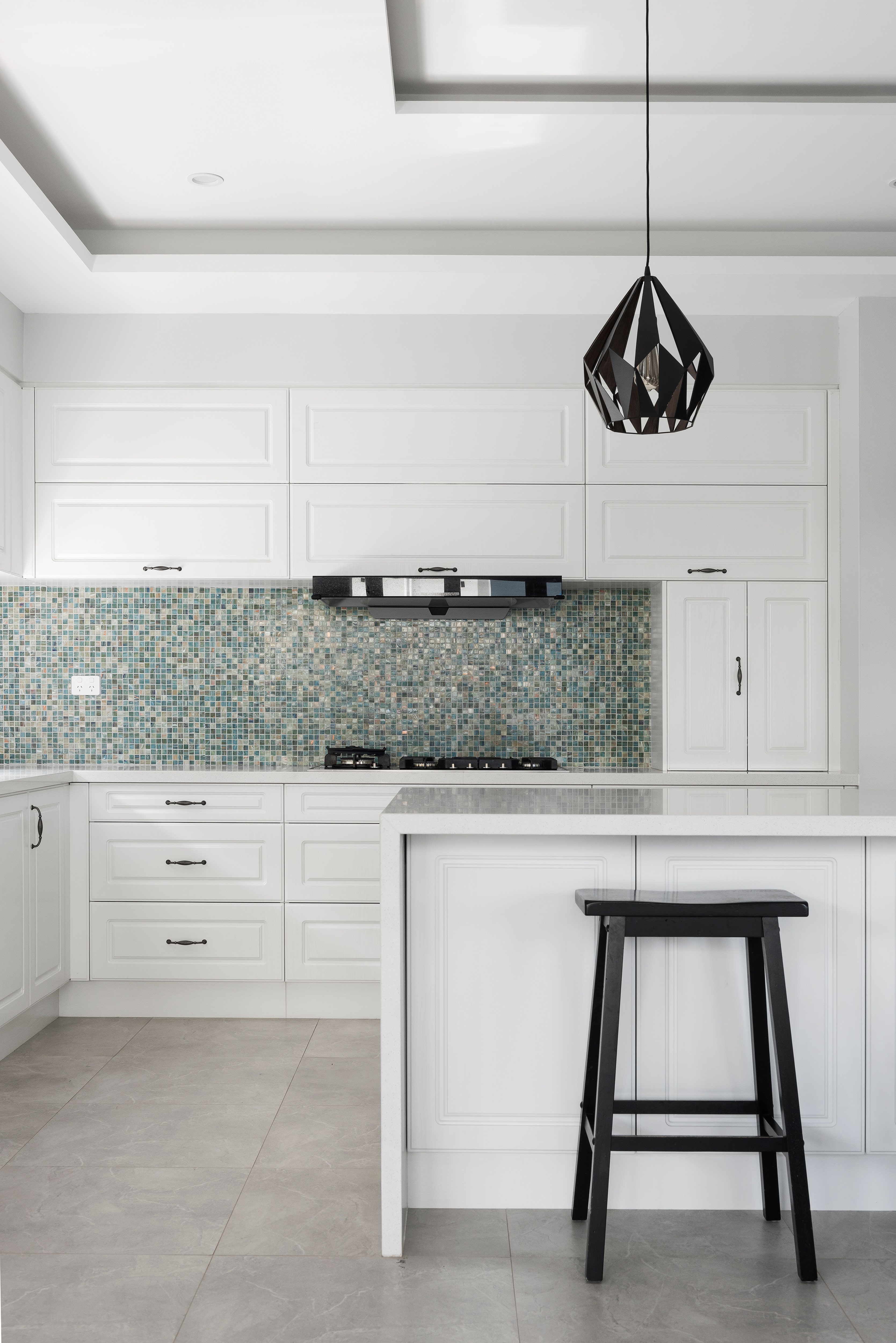 Glass mosaic tile on a kitchen splashback features a dazzling array of small, square glass tiles in a mix of colors and finishes.