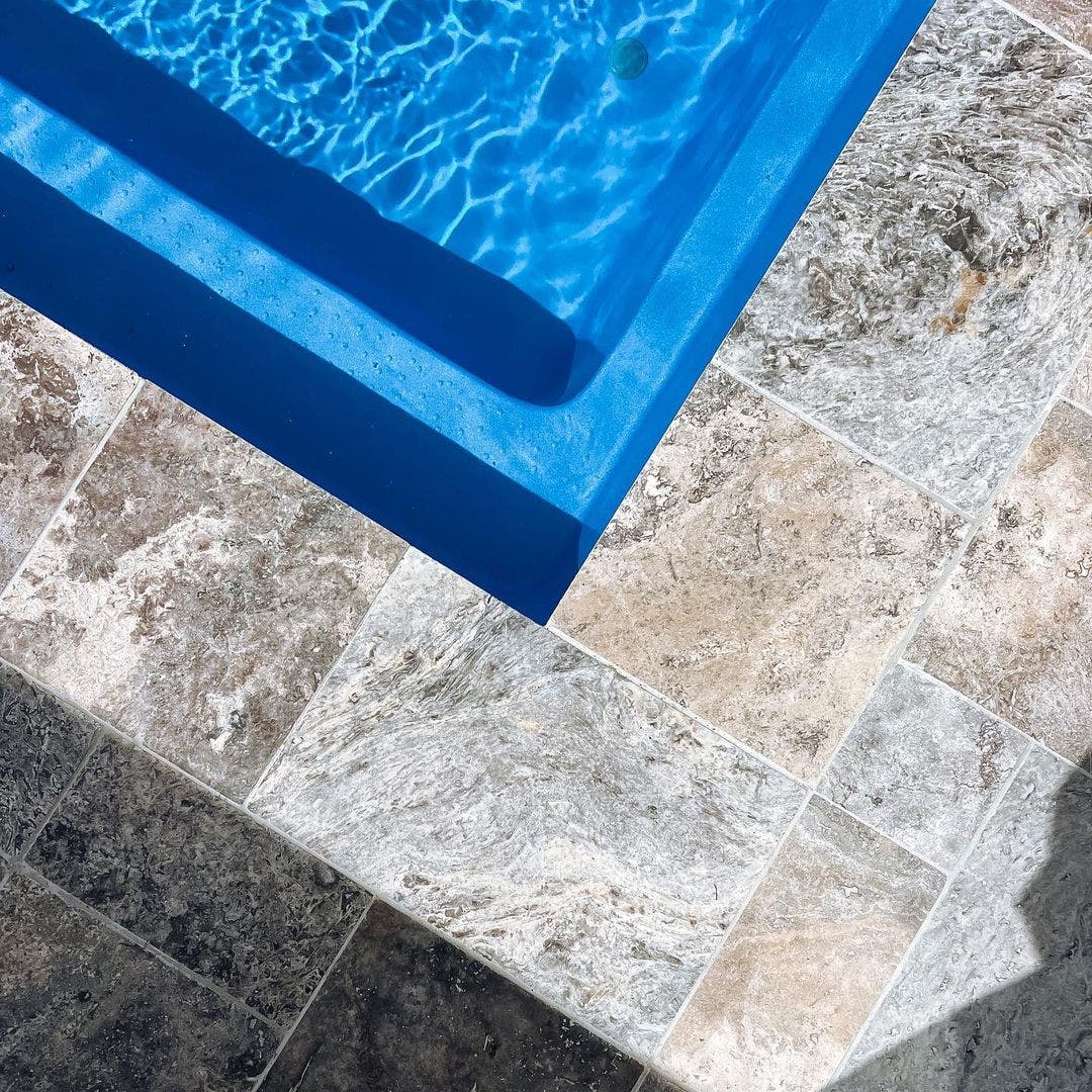 travertine paver laid around a pool from amber