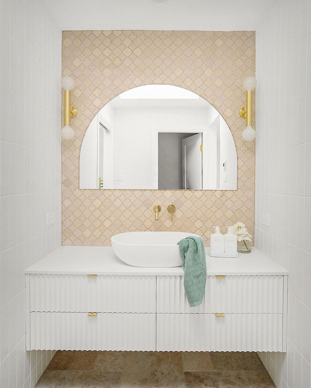 gorgeous bathroom with warm coloured mosaics as feature wall