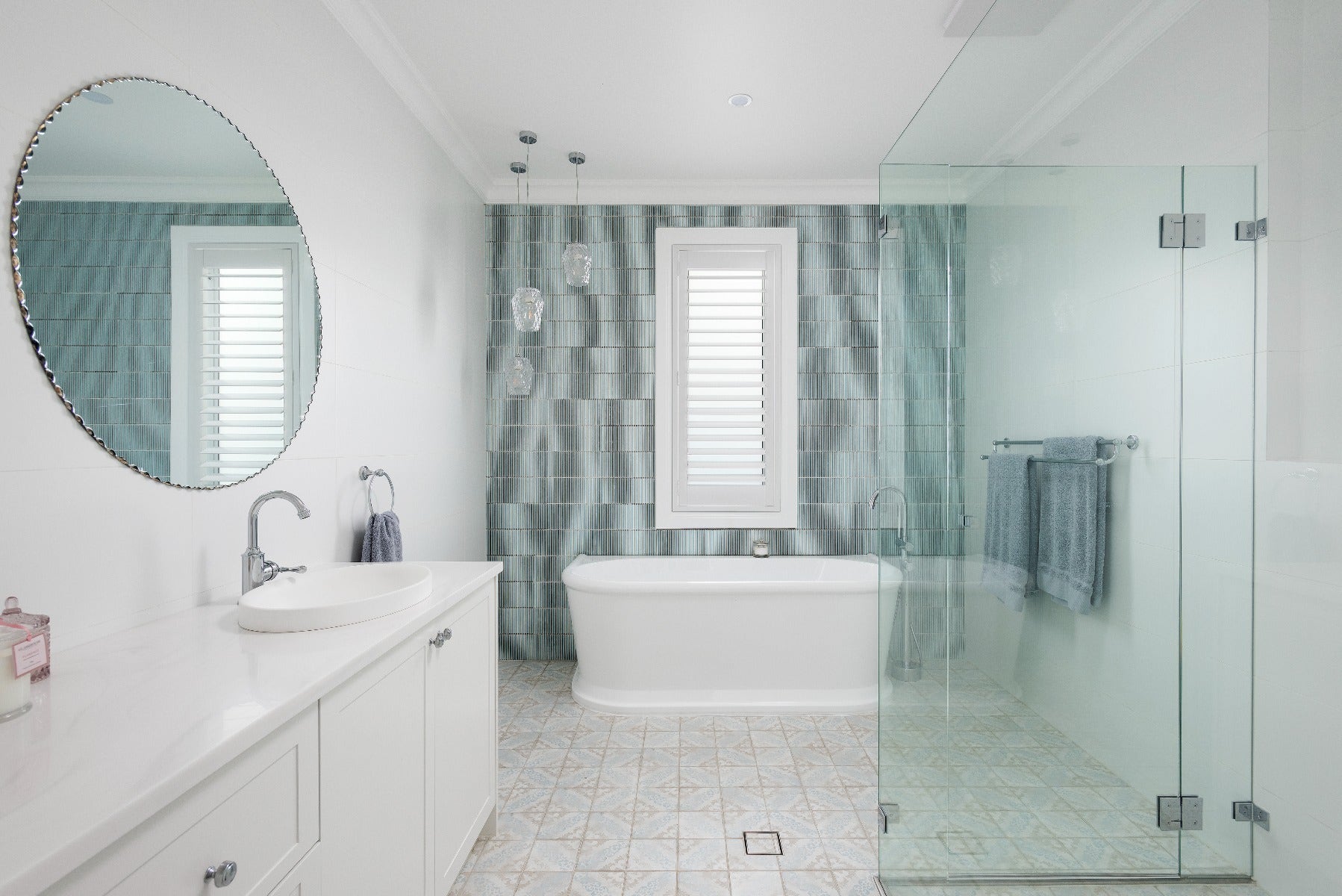 Elegant traditional bathroom featuring a stunning blue mosaic tile accent. purchased from amber