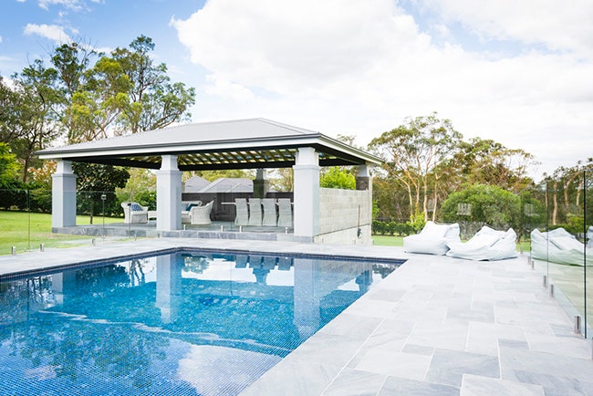 contemporary swimming pool with blue stone pavers