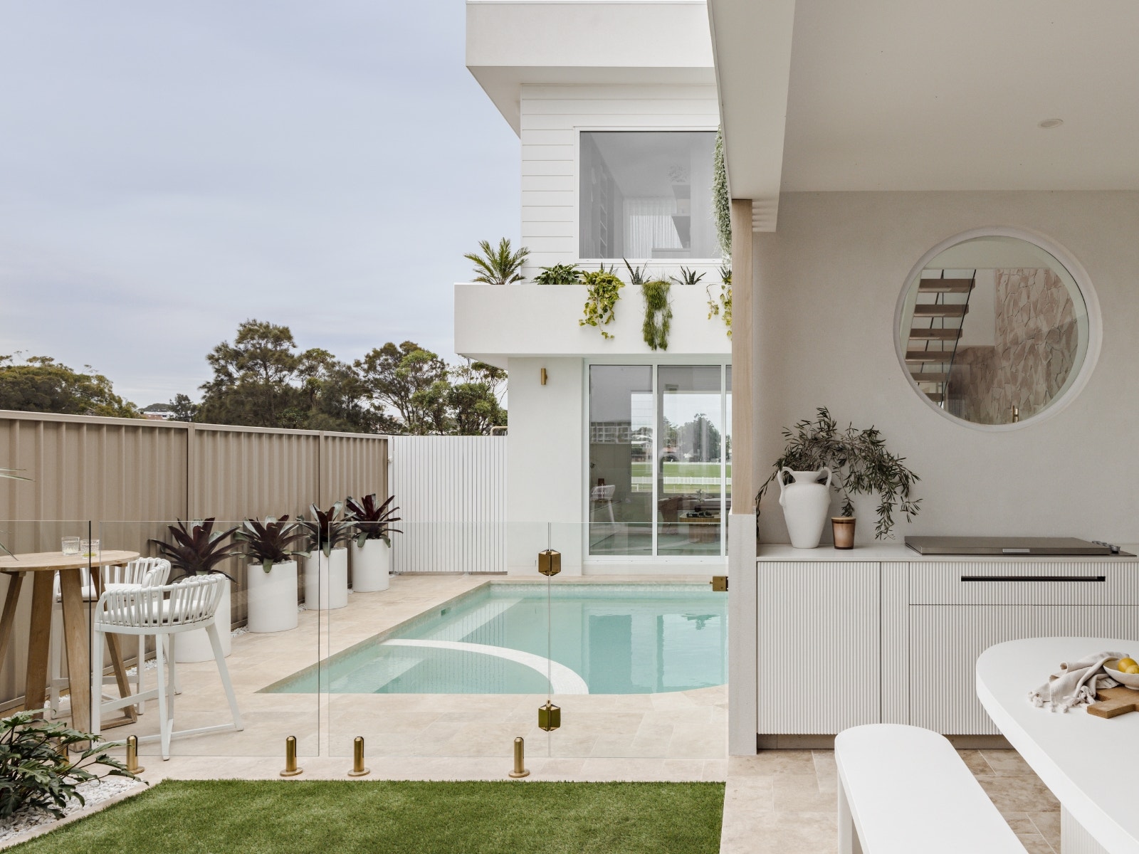 beautiful coastal palm spring inspired pool and alfresco by haaus design featuring travertine pavers from amber