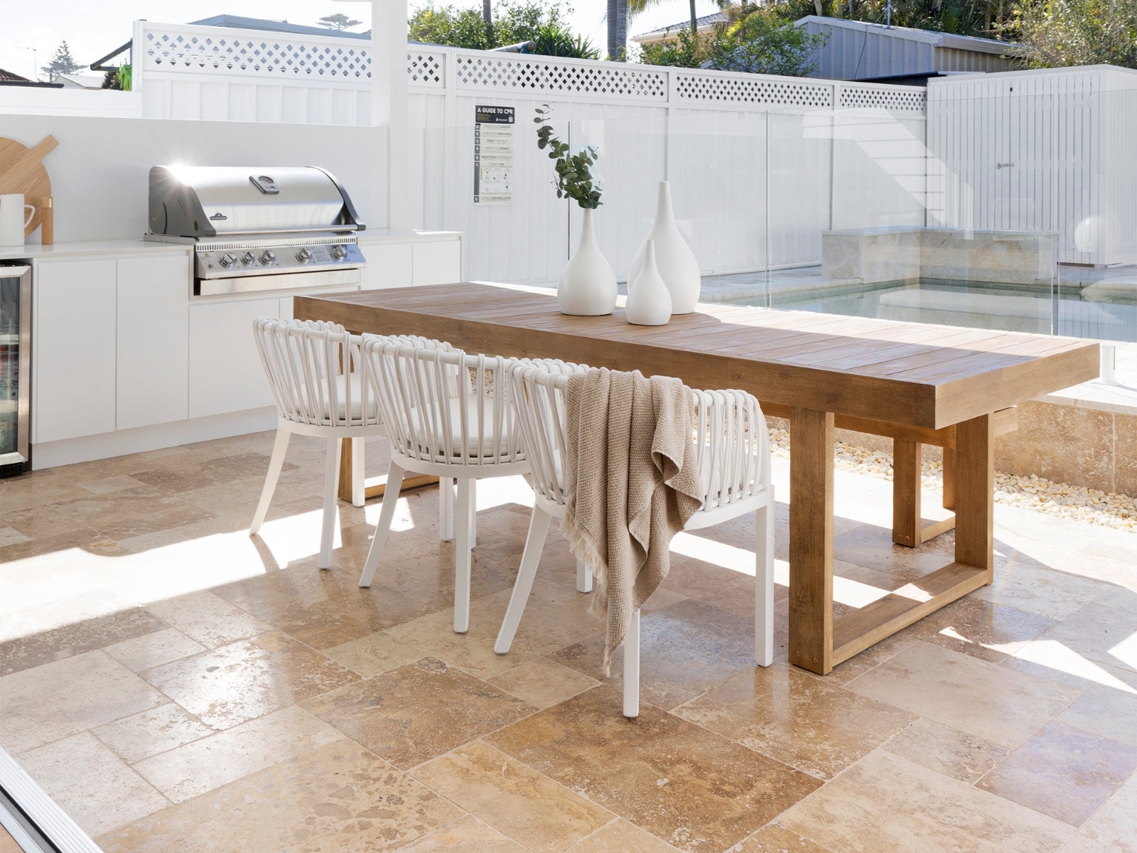 coastal palm spring inspired alfresco using travertine pavers and tiles in a french pattern. Haaus design project by amber