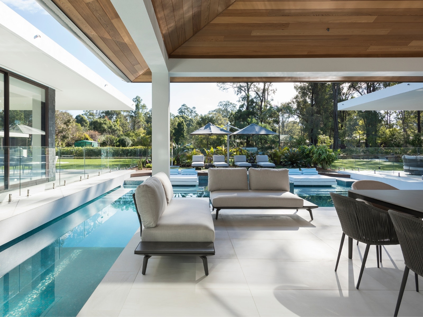 alfresco using stone pavers and blue pool mosaics from amber