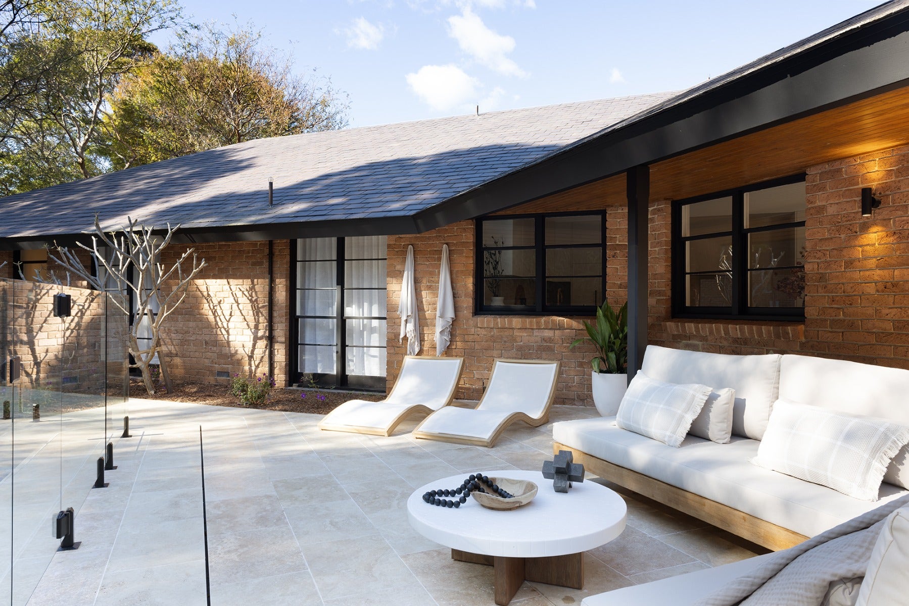 calming and relaxed outdoor space with travertine paved pool surround