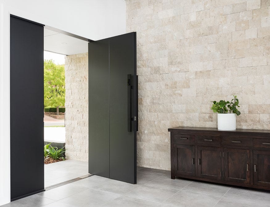 Inviting home entryway highlighted by stylish limestone cladding on the walls. The natural texture and subtle tones of the limestone create a warm, sophisticated entrance, adding timeless elegance and enhancing the curb appeal of the home. purchased from amber